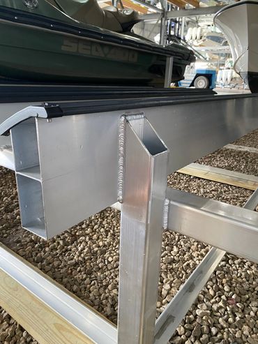 Close-up of a metal boat trailer frame with welding details.